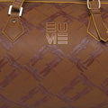Chopper Duffel Bag with embossed dragonfly pattern and logo.