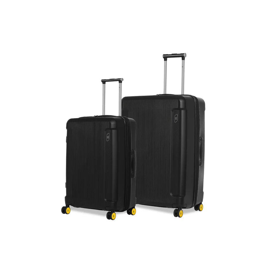 Black suitcases with yellow wheels, Nomad Cabin luggage collection.