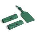 Green accessory kit featuring stylish cases and luggage tag.