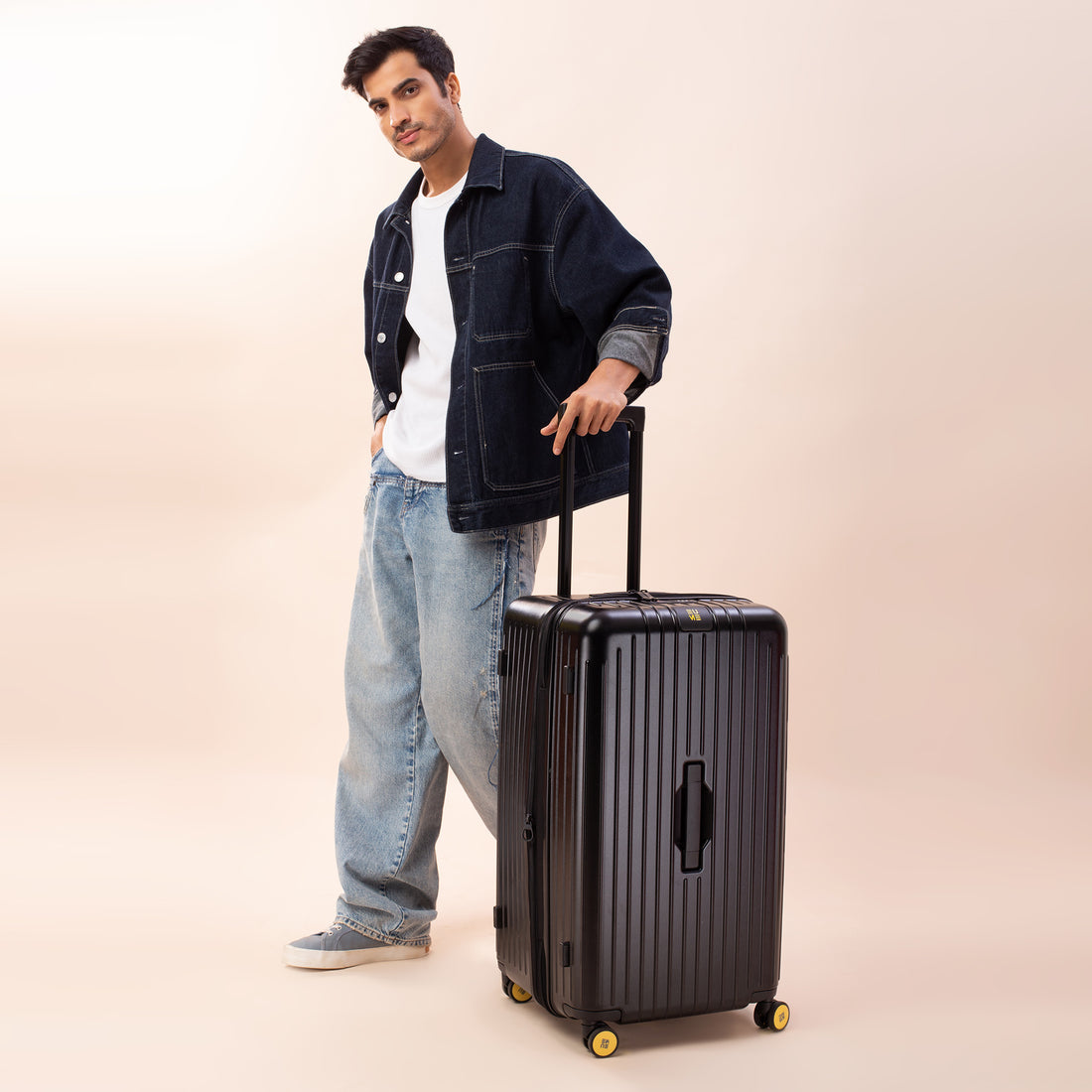 Stylish black hardshell suitcase with smooth-rolling wheels and retractable handle.