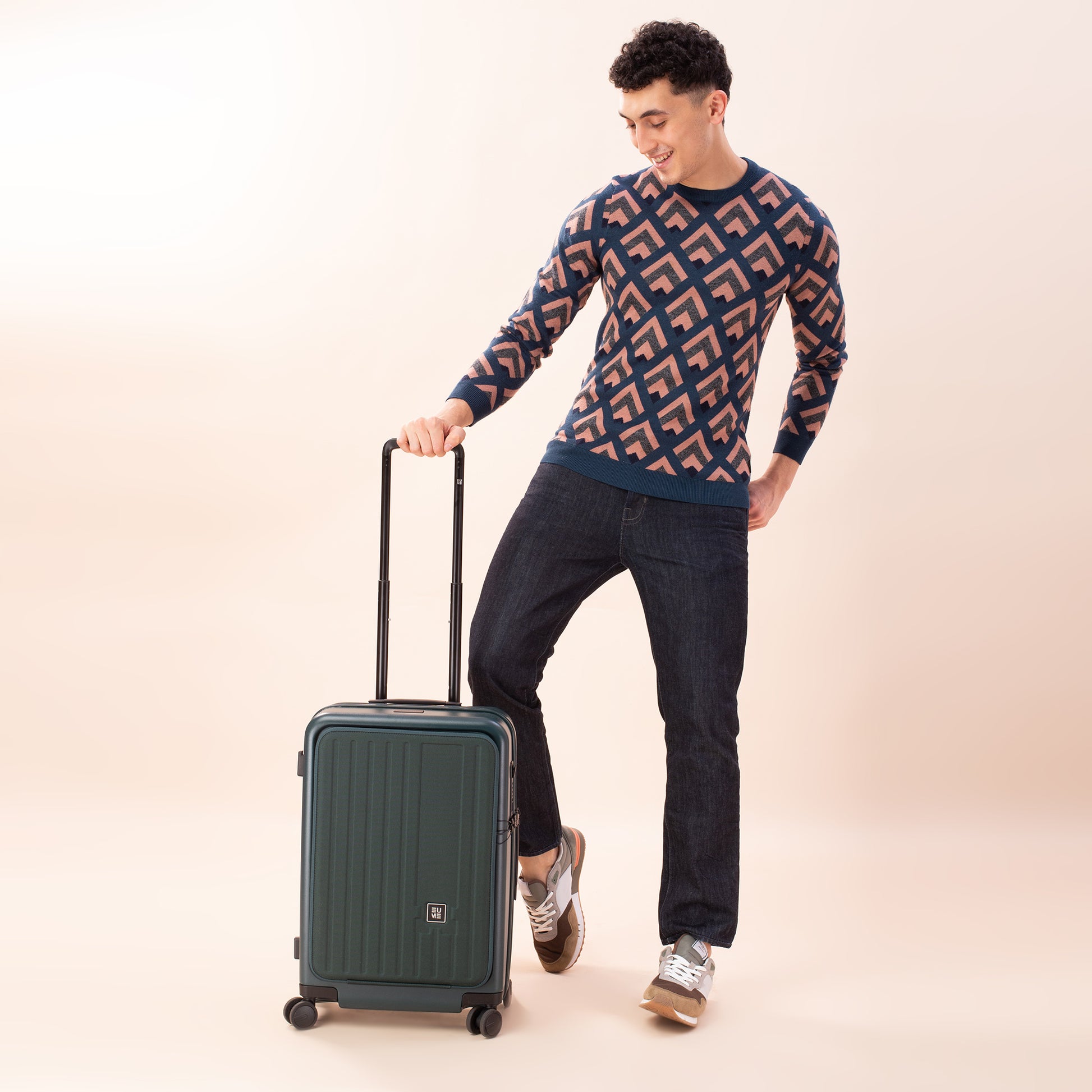 Man smiling with Cabin Pro suitcase against a light background.