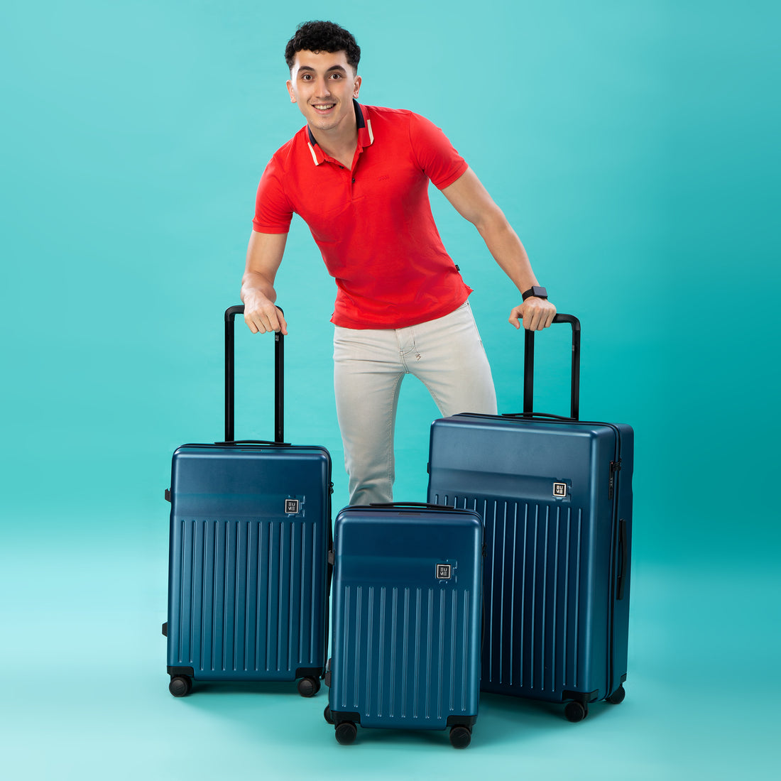 Two blue hard-shell suitcases with retractable handles and wheels.