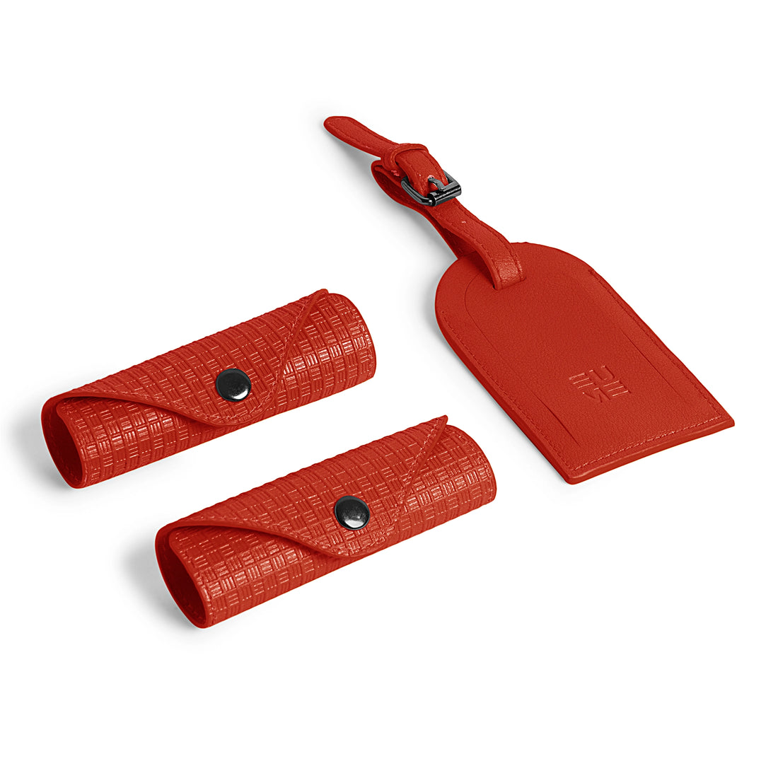 Red accessory kit featuring two roll cases and a luggage tag.