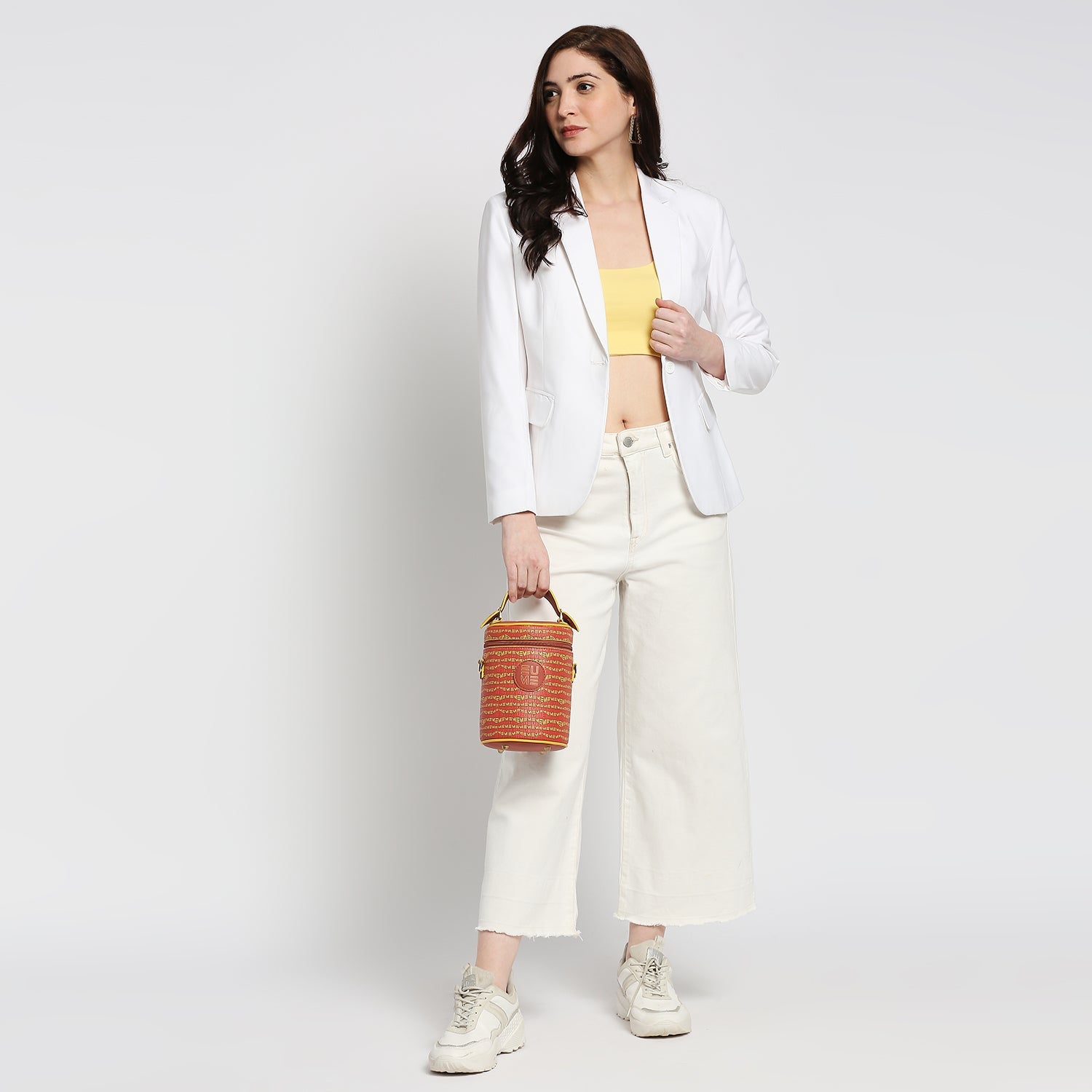 Stylish woman holding Picassu Cosmetic Bag in a chic outfit.