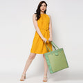 Stylish model showcasing the Cruiser Shoppers Handbag in bright colors.