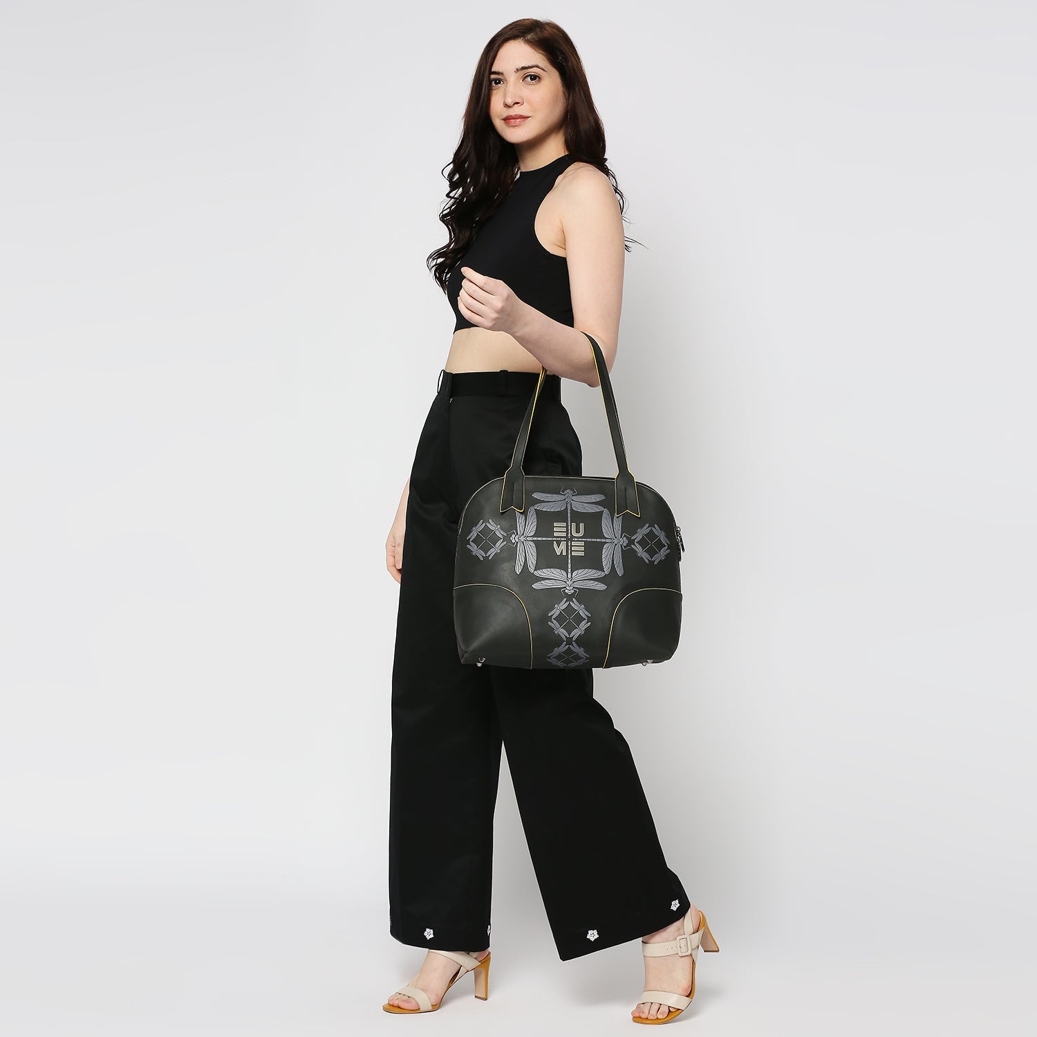 Luna Bowling Handbag displayed by model in stylish outfit.