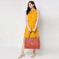 Flapper Laptop Handbag styled with a fashionable yellow dress.