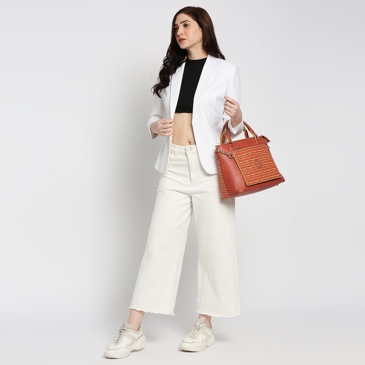 Model showcasing Skimmer Tote Handbag with stylish outfit.