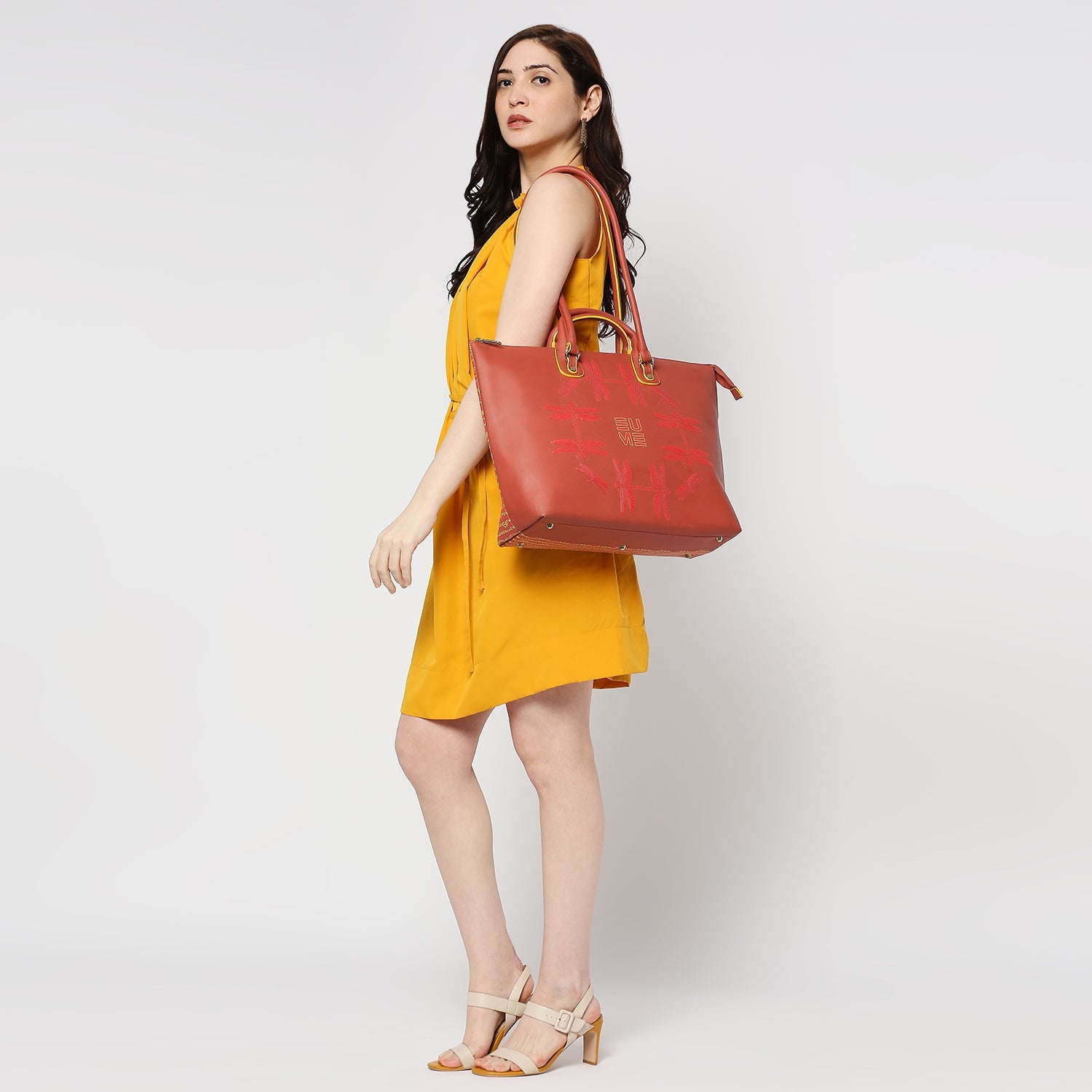 Broadwing Laptop Handbag in red, stylishly worn by a model.