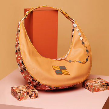 Cinnamon hobo bag with stylish design and vibrant colors.