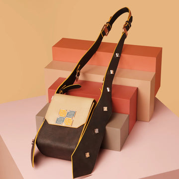 Mocha Satchel Bag on colored geometric blocks background.