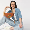 Stylish Pecan Saddle Bag showcased by a model in casual attire.