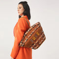 Praline Tote Bag worn by model in stylish orange outfit.