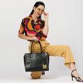 Daffodil satchel laptop handbag worn stylishly with colorful outfit.