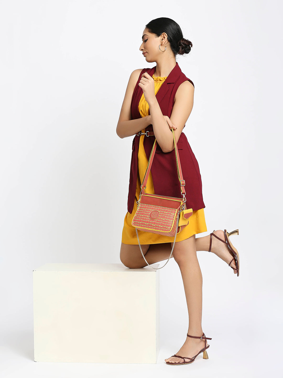 Damsel Saddle 2-in-1 detachable handbag in vibrant yellow and brown colors.