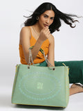 Flapper Laptop Handbag in green with stylish model showcasing.