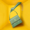 Spike-tail Satchel Handbag in green with decorative design, trendy fashion accessory.