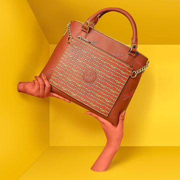 Stylish Skimmer Tote Handbag on a vibrant yellow background.