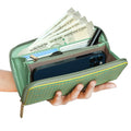 EUME Bandwing Clutch holding cash, cards, and smartphone.