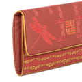 EUME Firefly Clutch in vibrant red with dragonfly design.