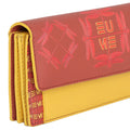 EUME Ladybug Clutch in red and yellow leather with embossed design.