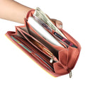 EUME Shaffronwing Clutch with organized compartments for cash and cards.