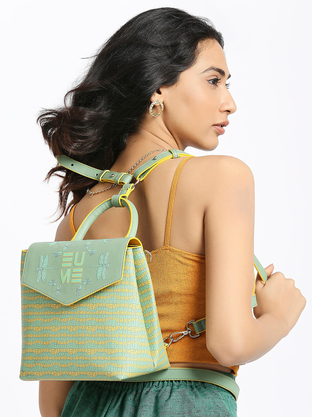 Petal-tail Sling Handbag/Backpack with adjustable straps on yellow background.