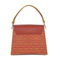 Spike-tail satchel handbag with unique red and yellow geometric pattern.