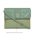 Stylish green messenger bag with adjustable sling and dragonfly design.