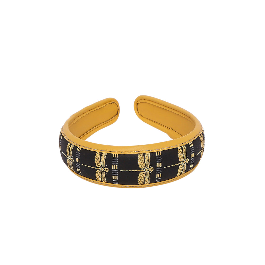 Stylish Gabbi Hairband with black and gold dragonfly design.