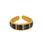 Stylish Gabbi Hairband with black and gold dragonfly design.