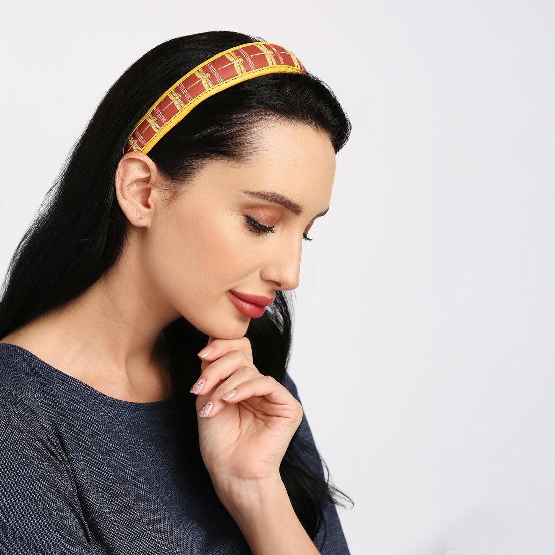 Elegant Gabbi Hairband in red and yellow on a model.