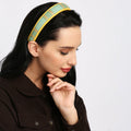 Stylish model wearing the Lola Hairband in teal and yellow.