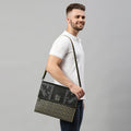 Man holding a stylish Streamer Messenger Bag, showcasing trendy design.