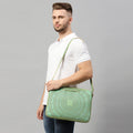 Man holding Dasher Laptop Sleeve in stylish green design.