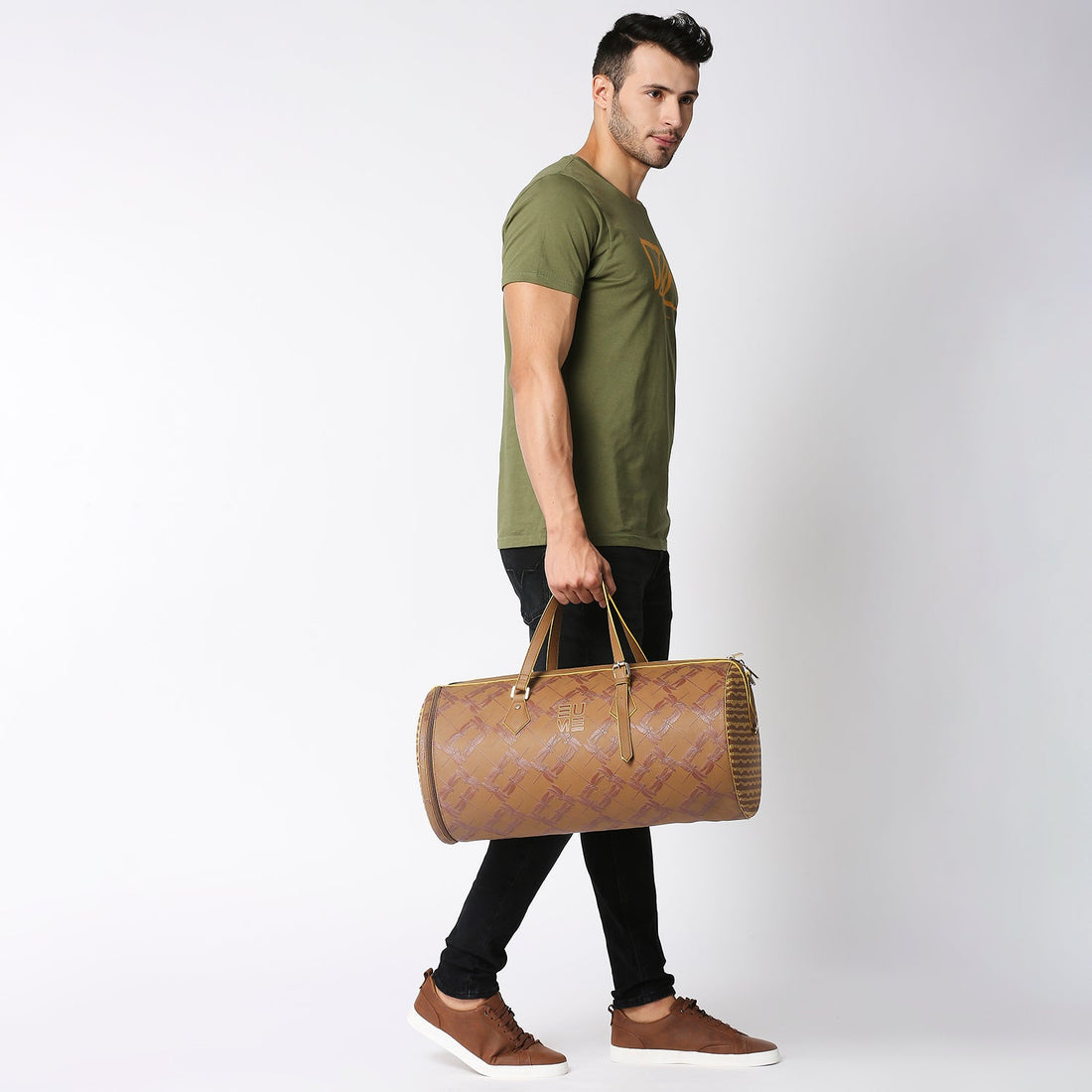 Chopper Duffel Bag in stylish brown against vibrant yellow backdrop.