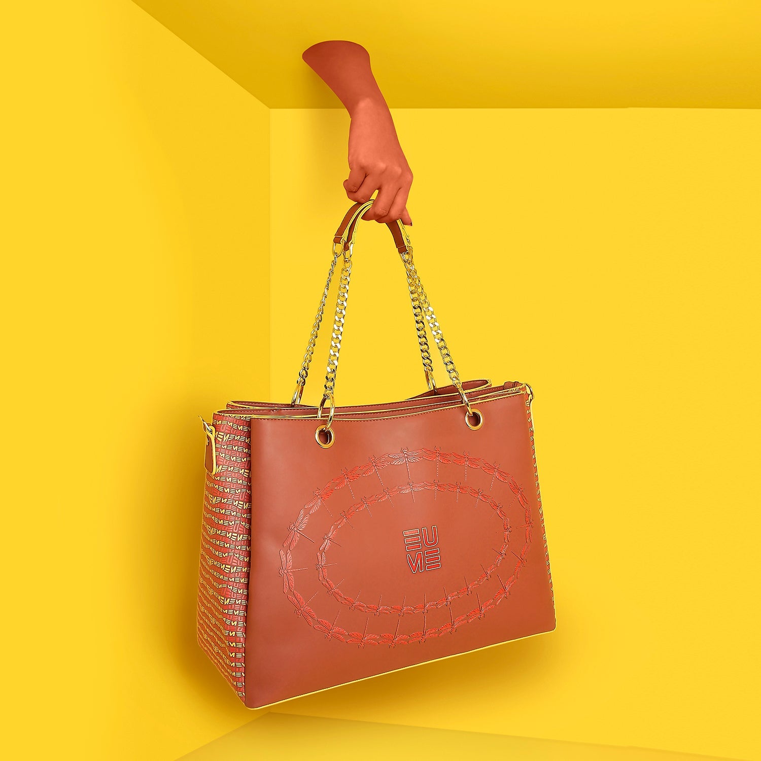 Stylish Flapper Laptop Handbag with chain handles against yellow background.