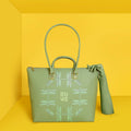 Broadwing Laptop Handbag in green with dragonfly design on yellow background.