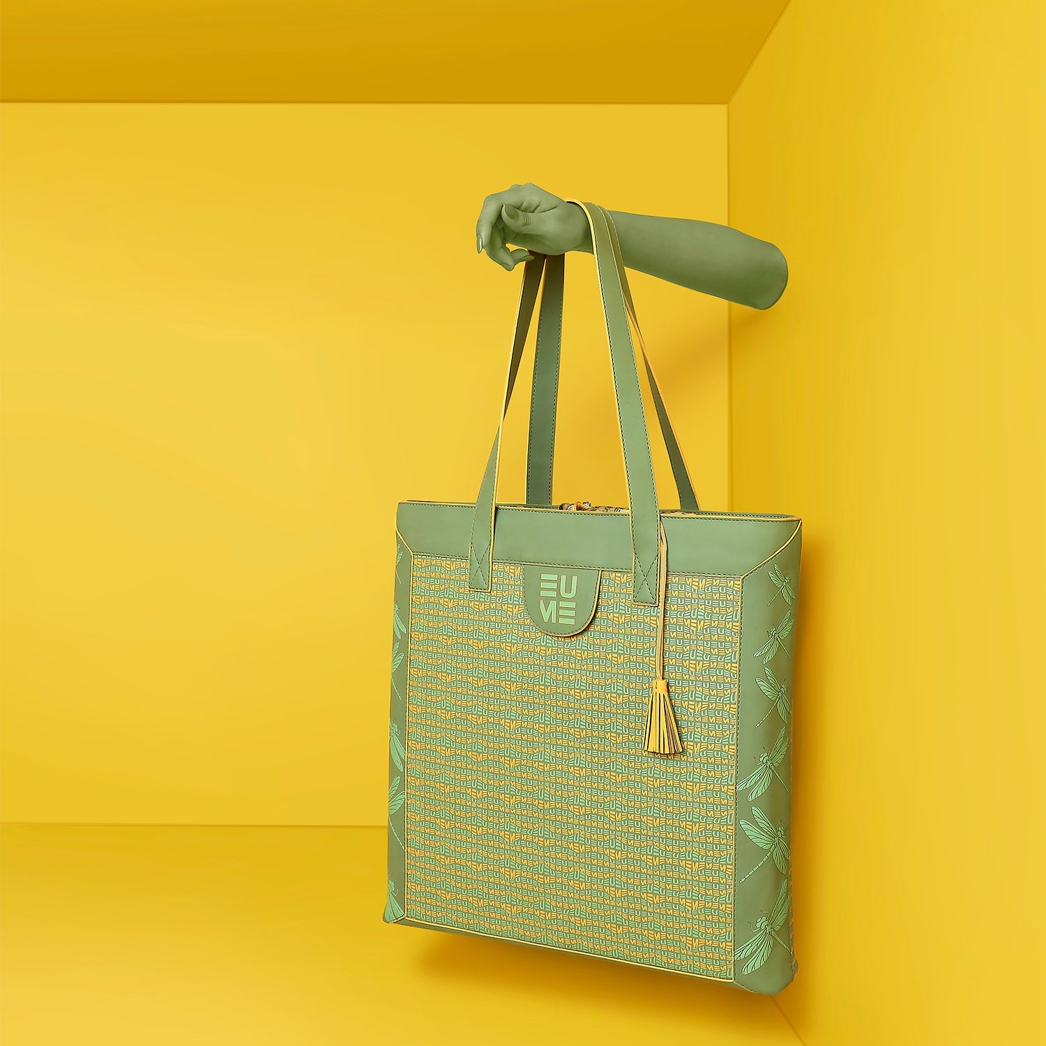 Stylish green Cruiser Shoppers Handbag displayed against a vibrant yellow background.