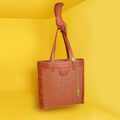 Cruiser Shoppers Handbag in vibrant colors against a yellow background.