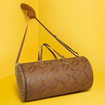 Chopper Duffel Bag in stylish brown against vibrant yellow backdrop.