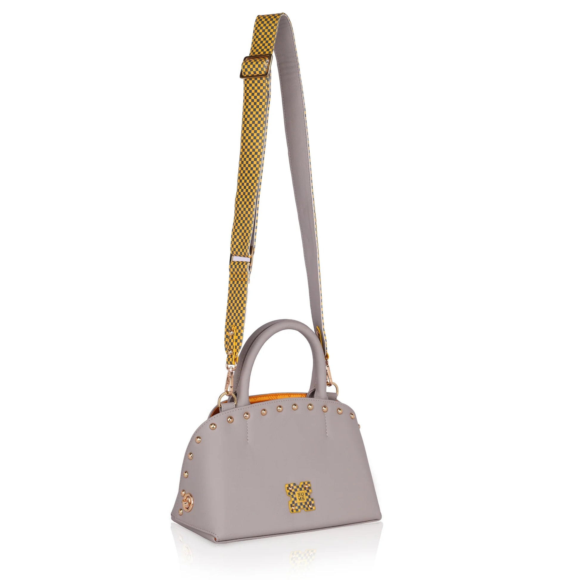 Stylish grey marigold satchel bag with checkered strap and embellishments.